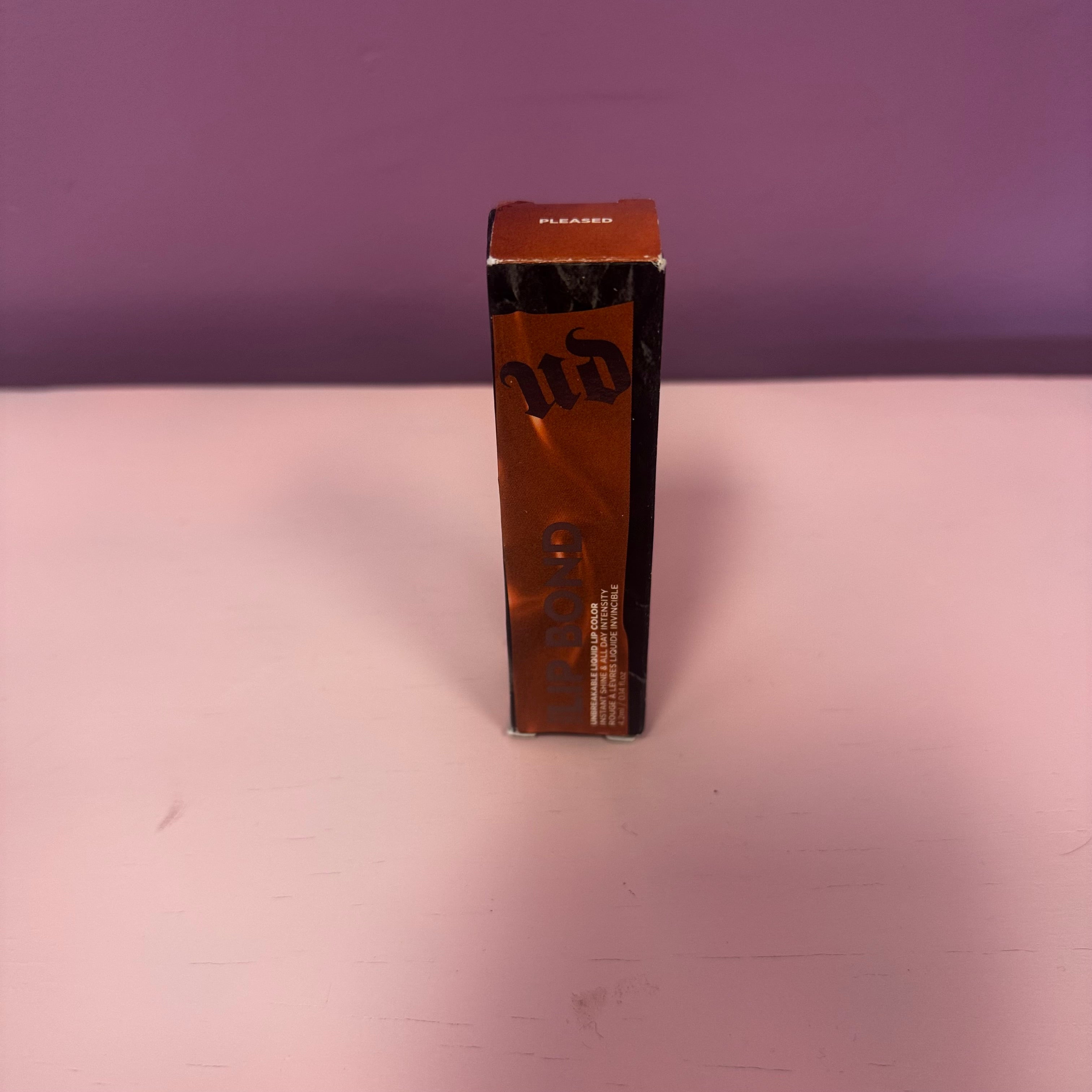 Urban Decay Lip Bond Glossy Lip Color in Pleased (0.2 fl oz / 6 mL).